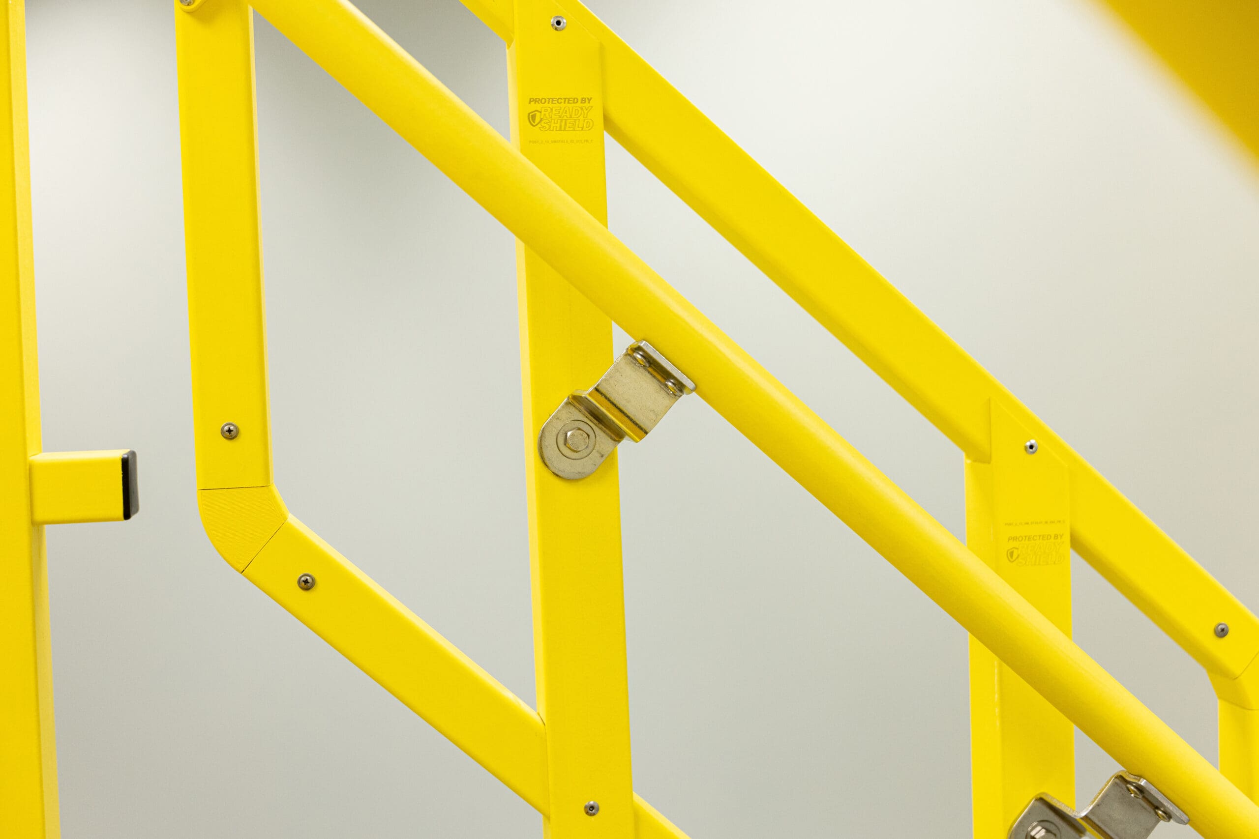 Yellow handrail with protected by ReadyShield on it