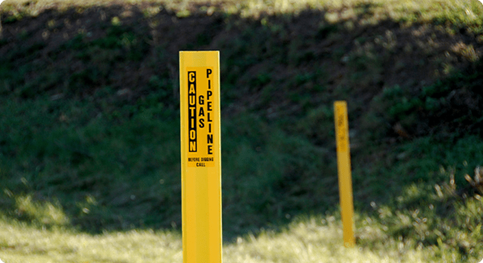 Gas pipeline marker in a grass field