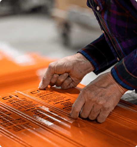 Man sticking decal onto marker