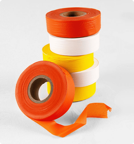 Orange, white and yellow rolls of marking tape