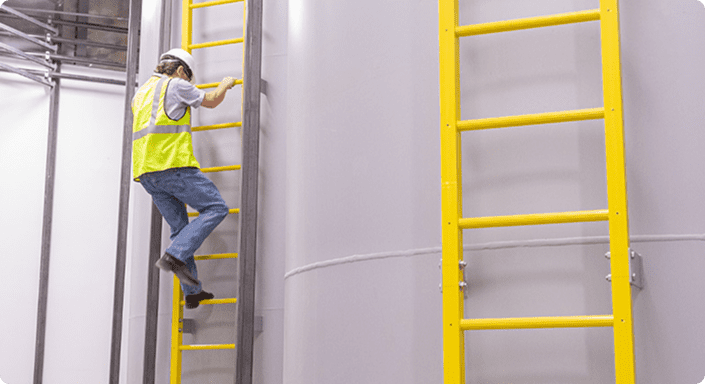 Employee climbing on a fixed ladder
