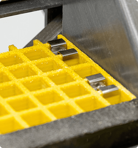 Close-up of m clips on molded grating, with stair tread on the front