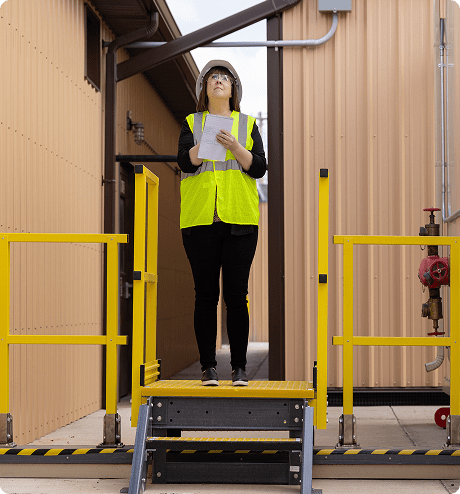 Woman crossing over a hazard using installed crossover stairs