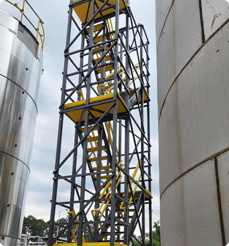 Modular switchback stairs spanning the height of a cylindrical tank