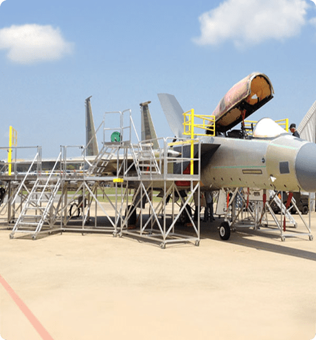 Rolling stairs being used to work on military aircraft