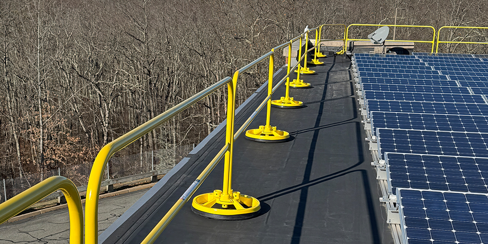 Non-penetrating safety railing on a building roof.